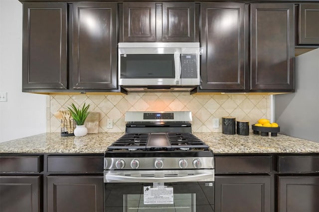 1812 Hidden Springs Path, Round Rock, TX 78665 - kitchen featuring dark brown cabinets, light stone counters, appliances with stainless steel finishes, and tasteful backsplash