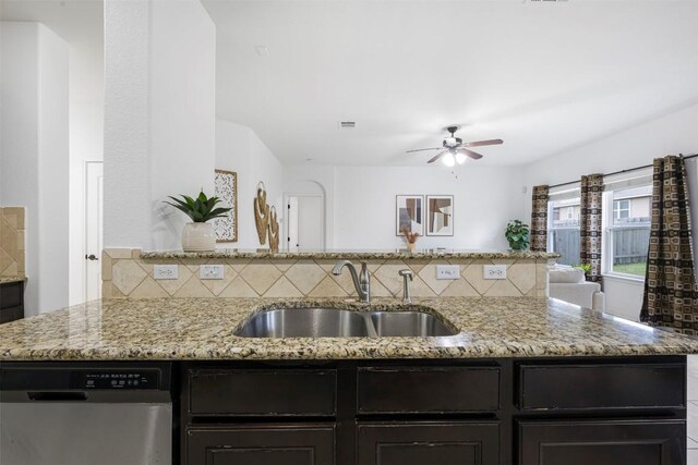 1812 Hidden Springs Path, Round Rock, TX 78665 - kitchen with stainless steel dishwasher, a sink, light stone counters, and decorative backsplash