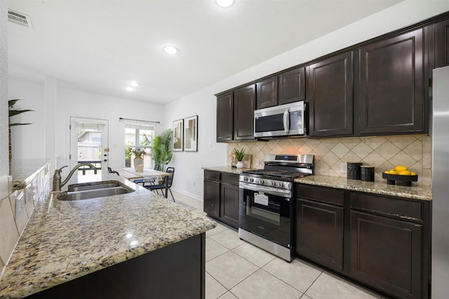 1812 Hidden Springs Path, Round Rock, TX 78665 - kitchen featuring a sink, visible vents, backsplash, appliances with stainless steel finishes, and light tile patterned floors