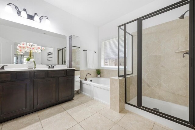 1812 Hidden Springs Path, Round Rock, TX 78665 - bathroom featuring a shower stall, a garden tub, double vanity, and tile patterned floors