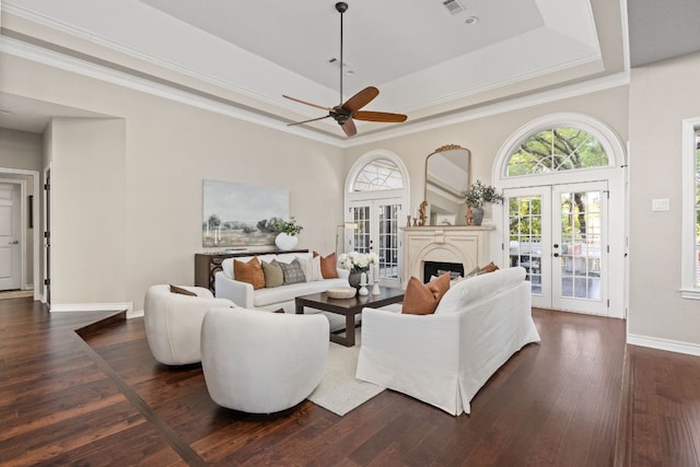 5710 Carry Back Ln, Austin, TX 78746 - living room featuring french doors, a tray ceiling, a ceiling fan, baseboards, and dark wood-style floors
