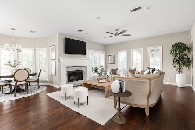 5710 Carry Back Ln, Austin, TX 78746 - living area with a ceiling fan, a high end fireplace, dark wood-style flooring, baseboards, and a chandelier