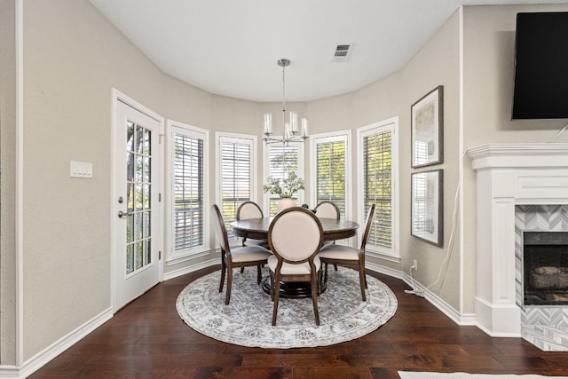 5710 Carry Back Ln, Austin, TX 78746 - dining space with dark wood-style floors, a chandelier, a high end fireplace, and baseboards