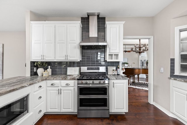 5710 Carry Back Ln, Austin, TX 78746 - kitchen with wall chimney exhaust hood, stainless steel appliances, tasteful backsplash, a chandelier, and white cabinets