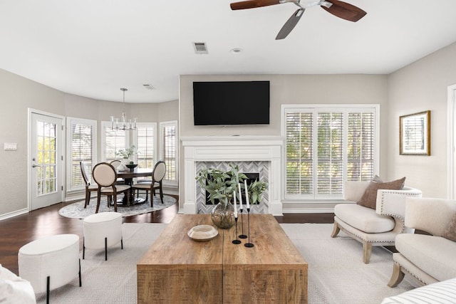 5710 Carry Back Ln, Austin, TX 78746 - living area featuring ceiling fan, healthy amount of natural light, a tile fireplace, and a chandelier