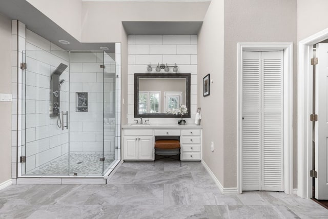 5710 Carry Back Ln, Austin, TX 78746 - bathroom with a closet, a stall shower, vanity, baseboards, and marble finish flooring