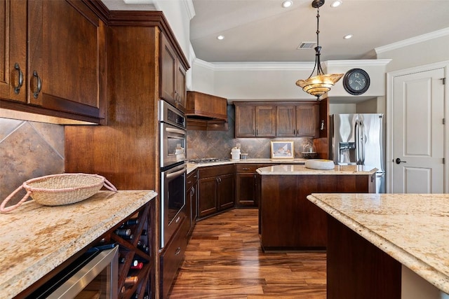 27435 Waterfall Hill Pkwy, Spicewood, TX 78669 - kitchen with recessed lighting, crown molding, appliances with stainless steel finishes, and dark wood-type flooring