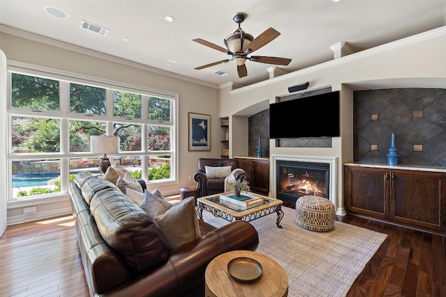 27435 Waterfall Hill Pkwy, Spicewood, TX 78669 - living area with a wealth of natural light, visible vents, a ceiling fan, and a glass covered fireplace