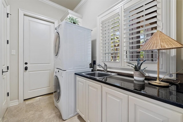 27435 Waterfall Hill Pkwy, Spicewood, TX 78669 - laundry room featuring stacked washer and clothes dryer, crown molding, cabinet space, and a sink