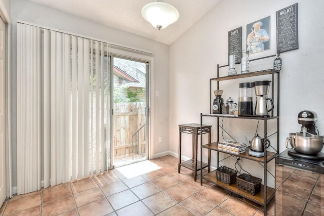 interior space featuring tile patterned floors and vaulted ceiling