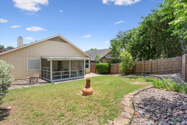 2203 Nathan Dr, Austin, TX 78728 - rear view of house featuring a fenced backyard, a sunroom, and a chimney