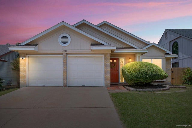 2203 Nathan Dr, Austin, TX 78728 - view of front of property with a garage, driveway, brick siding, and a front yard