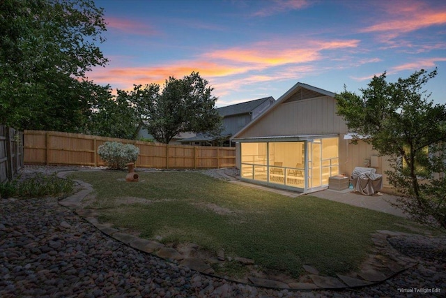2203 Nathan Dr, Austin, TX 78728 - rear view of house featuring a fenced backyard and a sunroom
