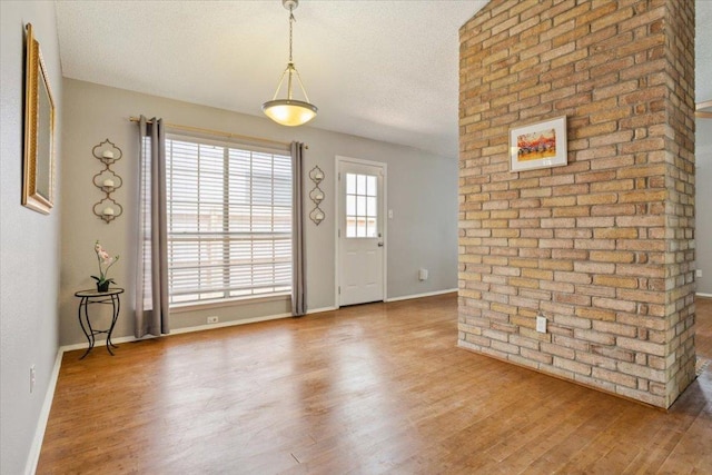2203 Nathan Dr, Austin, TX 78728 - entrance foyer featuring wood finished floors and a textured ceiling