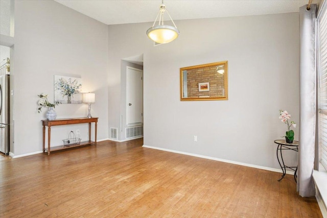 2203 Nathan Dr, Austin, TX 78728 - spare room with light wood finished floors, plenty of natural light, and high vaulted ceiling