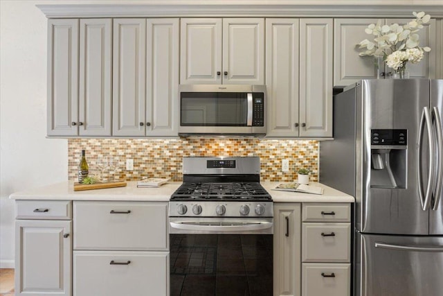 2203 Nathan Dr, Austin, TX 78728 - kitchen featuring stainless steel appliances, light countertops, tasteful backsplash, and tile patterned floors