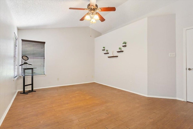 2203 Nathan Dr, Austin, TX 78728 - spare room featuring vaulted ceiling, ceiling fan, and light wood-style flooring