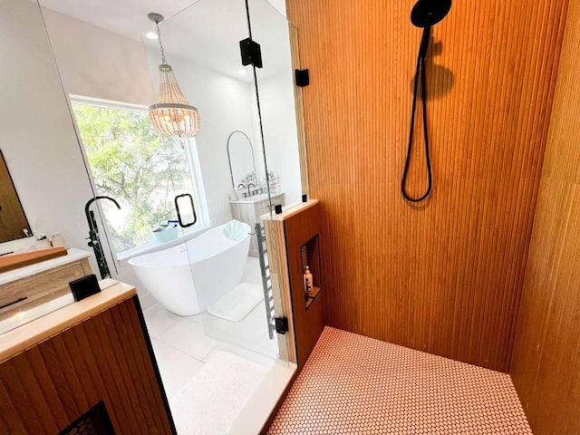 bathroom with a soaking tub, a notable chandelier, walk in shower, tile patterned flooring, and vanity