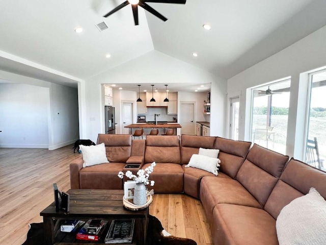 living area featuring recessed lighting, light wood finished floors, visible vents, high vaulted ceiling, and ceiling fan