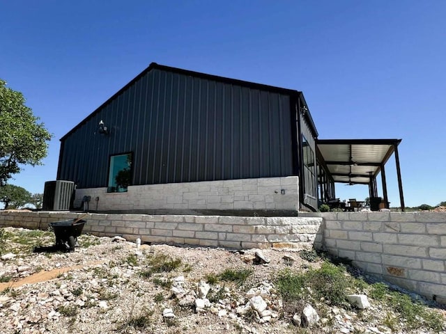 view of side of property featuring stone siding and board and batten siding