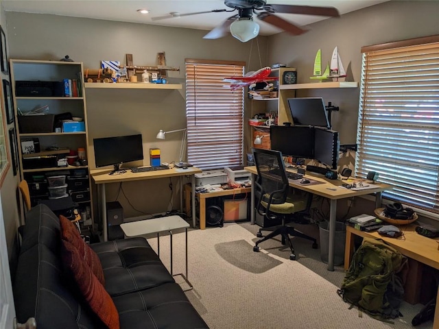 carpeted office featuring a ceiling fan