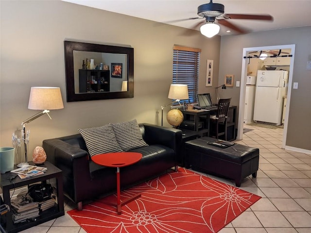 living area with a ceiling fan and tile patterned flooring