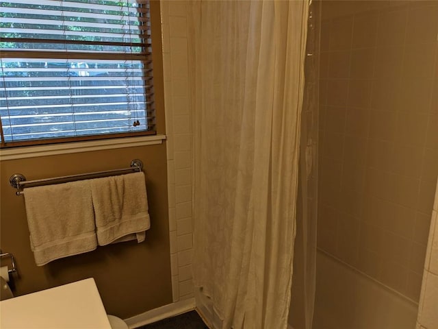 full bath featuring shower / tub combo and toilet