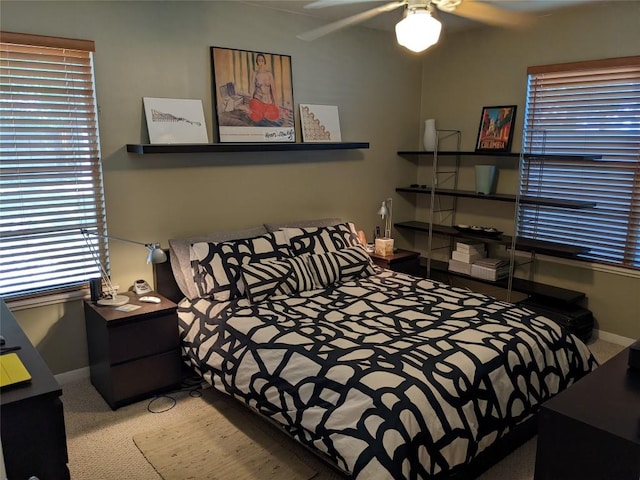 bedroom featuring baseboards, carpet flooring, and multiple windows