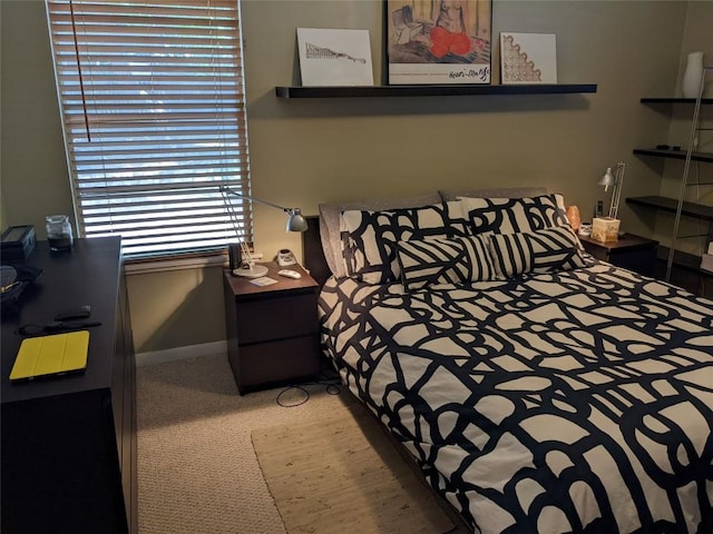 carpeted bedroom featuring baseboards