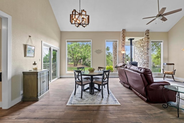 9 Stoney Creek Cv, Lakeway, TX 78734 - dining area with high vaulted ceiling, plenty of natural light, a chandelier, wood finished floors, and a wood stove