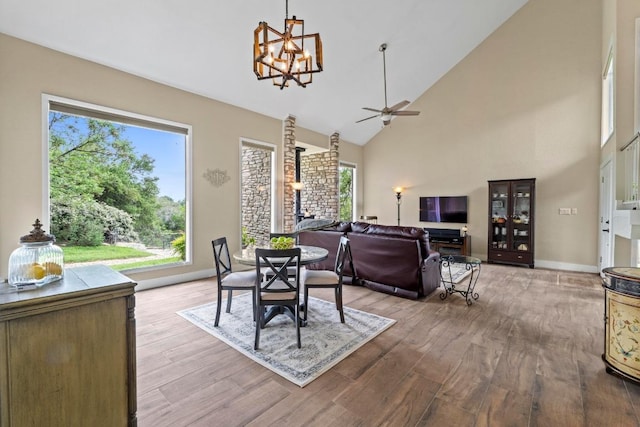9 Stoney Creek Cv, Lakeway, TX 78734 - dining room with a chandelier, plenty of natural light, wood finished floors, ceiling fan, and high vaulted ceiling