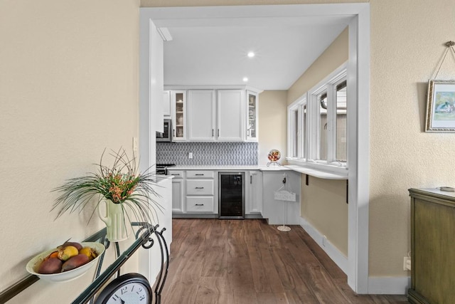 9 Stoney Creek Cv, Lakeway, TX 78734 - bar featuring wine cooler, backsplash, stainless steel microwave, dark wood finished floors, and recessed lighting