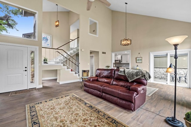 9 Stoney Creek Cv, Lakeway, TX 78734 - living room with high vaulted ceiling, stairway, a chandelier, wood finished floors, and ceiling fan