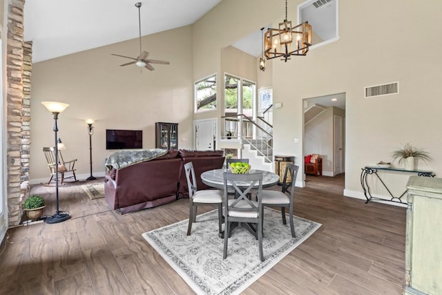9 Stoney Creek Cv, Lakeway, TX 78734 - dining space featuring stairway, high vaulted ceiling, ceiling fan, wood finished floors, and a chandelier