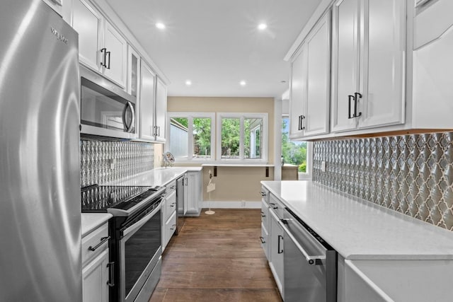 9 Stoney Creek Cv, Lakeway, TX 78734 - kitchen with appliances with stainless steel finishes, light countertops, backsplash, recessed lighting, and dark wood finished floors