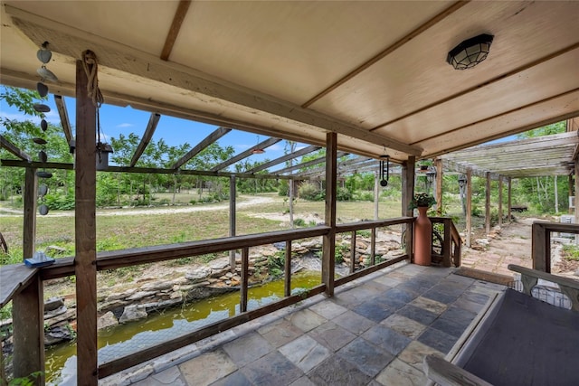 unfurnished sunroom with a water view