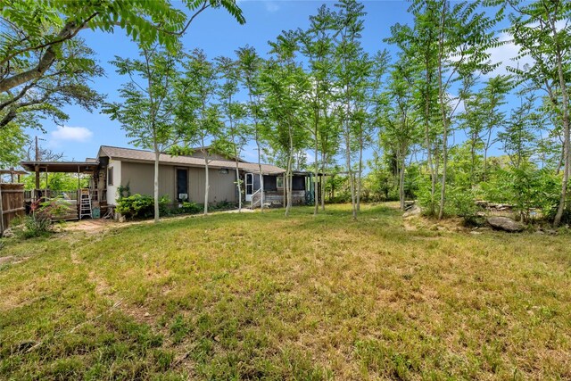 view of yard featuring stairway and fence