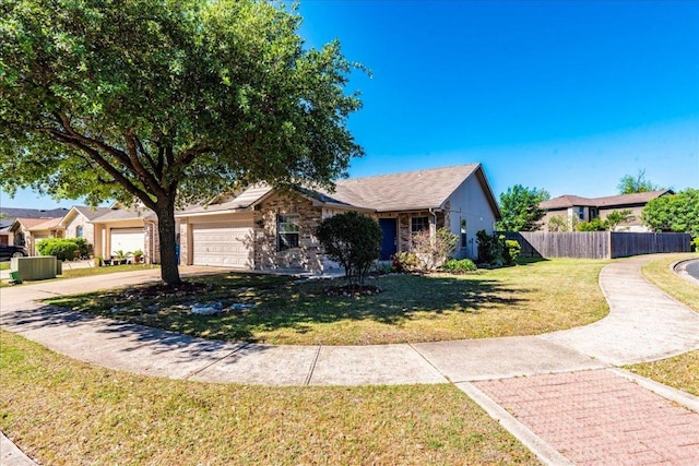 219 Quarry Ln, Liberty Hill, TX 78642 - view of front facade with fence, a front lawn, an attached garage, driveway, and stone siding
