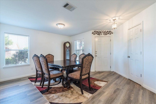 219 Quarry Ln, Liberty Hill, TX 78642 - dining room with wood finished floors, visible vents, and baseboards