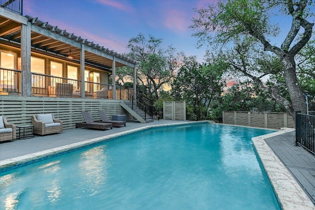 8105 Bell Mountain Dr, Austin, TX 78730 - pool at dusk with stairs and a wooden deck