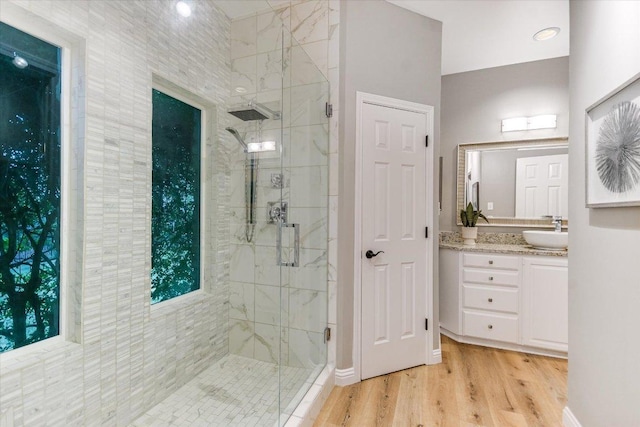 8105 Bell Mountain Dr, Austin, TX 78730 - bathroom featuring a marble finish shower, vanity, and wood finished floors