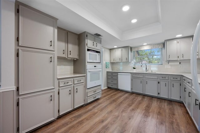 1609 Oak Forest Dr, Round Rock, TX 78681 - kitchen with white appliances, a sink, gray cabinetry, a tray ceiling, and recessed lighting