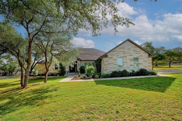 view of front of home featuring stone siding and a front yard