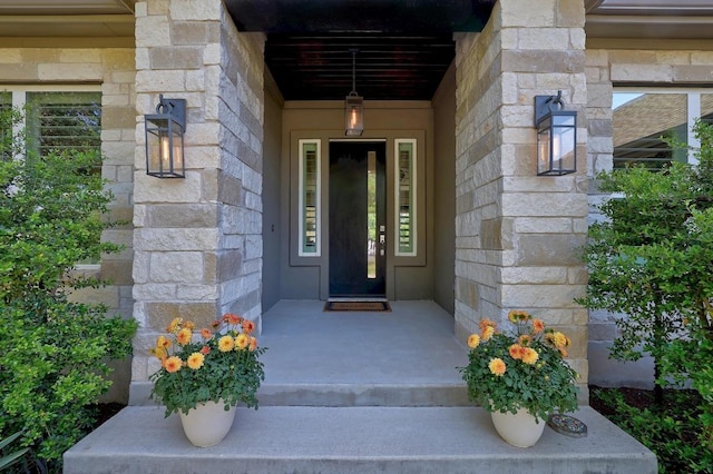doorway to property with stone siding