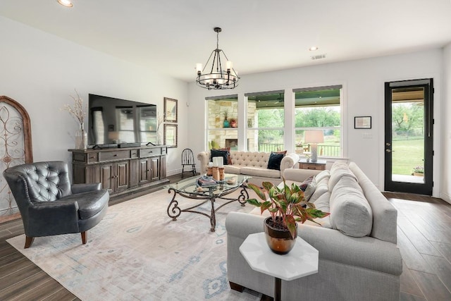 living area with a chandelier, light wood-style floors, visible vents, and recessed lighting