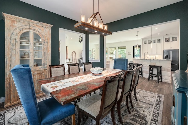 dining area with wood finished floors and recessed lighting
