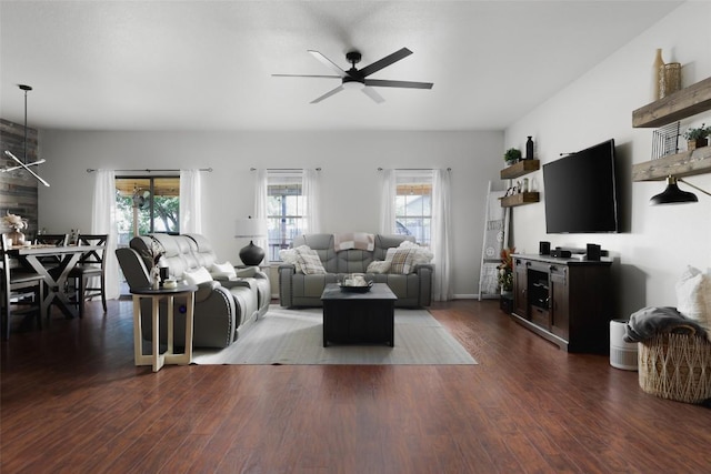 living room with a ceiling fan and dark wood-style floors