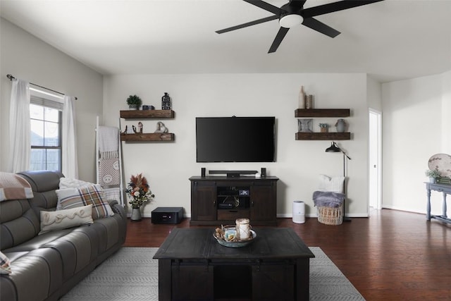 living area with wood finished floors, baseboards, and ceiling fan