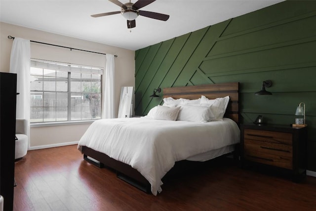 bedroom with baseboards, a ceiling fan, and wood finished floors