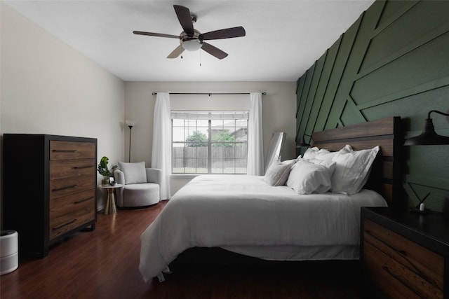 bedroom with a ceiling fan and dark wood-style flooring